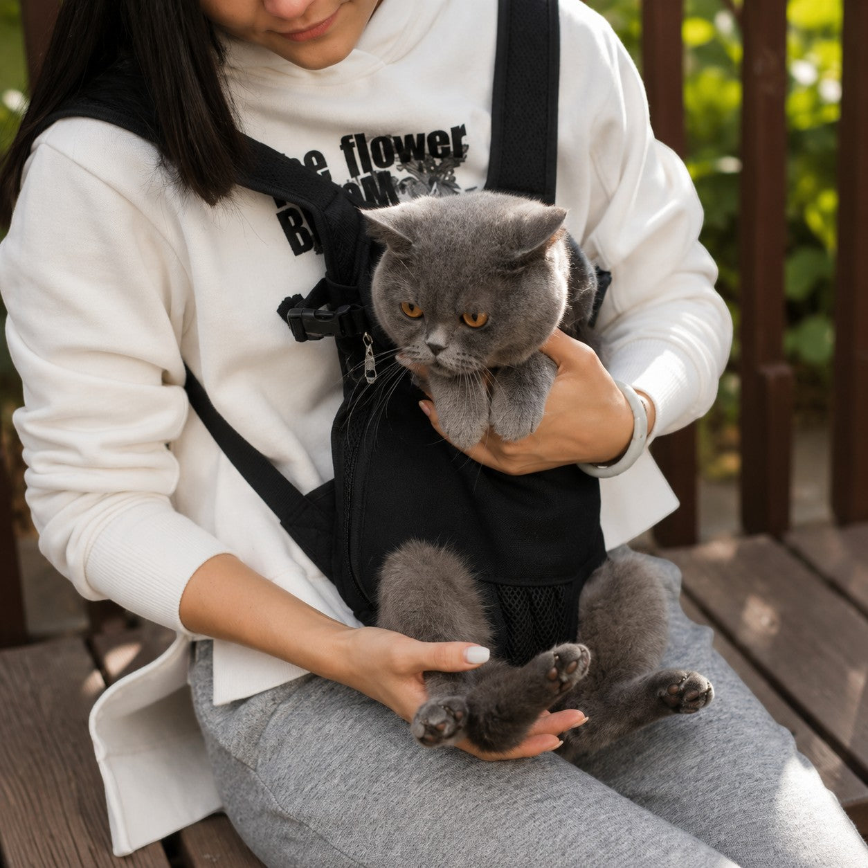 Mincy Pets breathable black mesh cat carrier backpack worn on the front with a grey cat inside