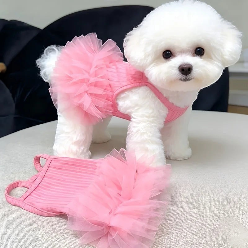 Mincy Pets blush pink strapless wedding gown with a puffy tulle skirt worn by a white Bichon Frise dog.