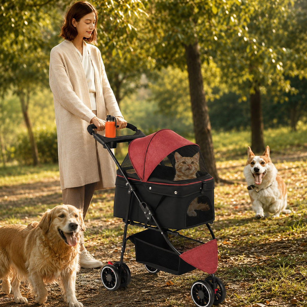 Mincy Pets 3-wheel foldable pet stroller with red canopy and mesh windows, being pushed by a woman in a park.