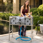 Mincy Pets foldable elevated dog bathtub with paw print pattern and blue drain hose, used outdoors by a woman.