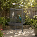 Mincy Pets large metal bird cage with play top, wood perches, and rolling wheels in a garden setting.
