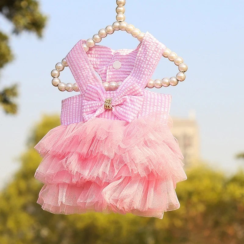 Mincy Pets pink striped dog dress with a tulle skirt, bow detail, and pearl-accented hanger