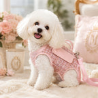 Mincy Pets pink tweed dog lift harness backpack worn by a white Bichon Frise on a soft cream rug