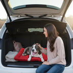 Mincy Pets waterproof red dog travel mat in a car trunk with a woman petting her dog during a road trip