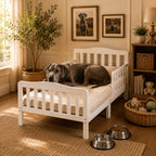 Mincy Pets white wooden XXL platform dog bed with guardrails and a large Great Dane resting on a beige mattress.